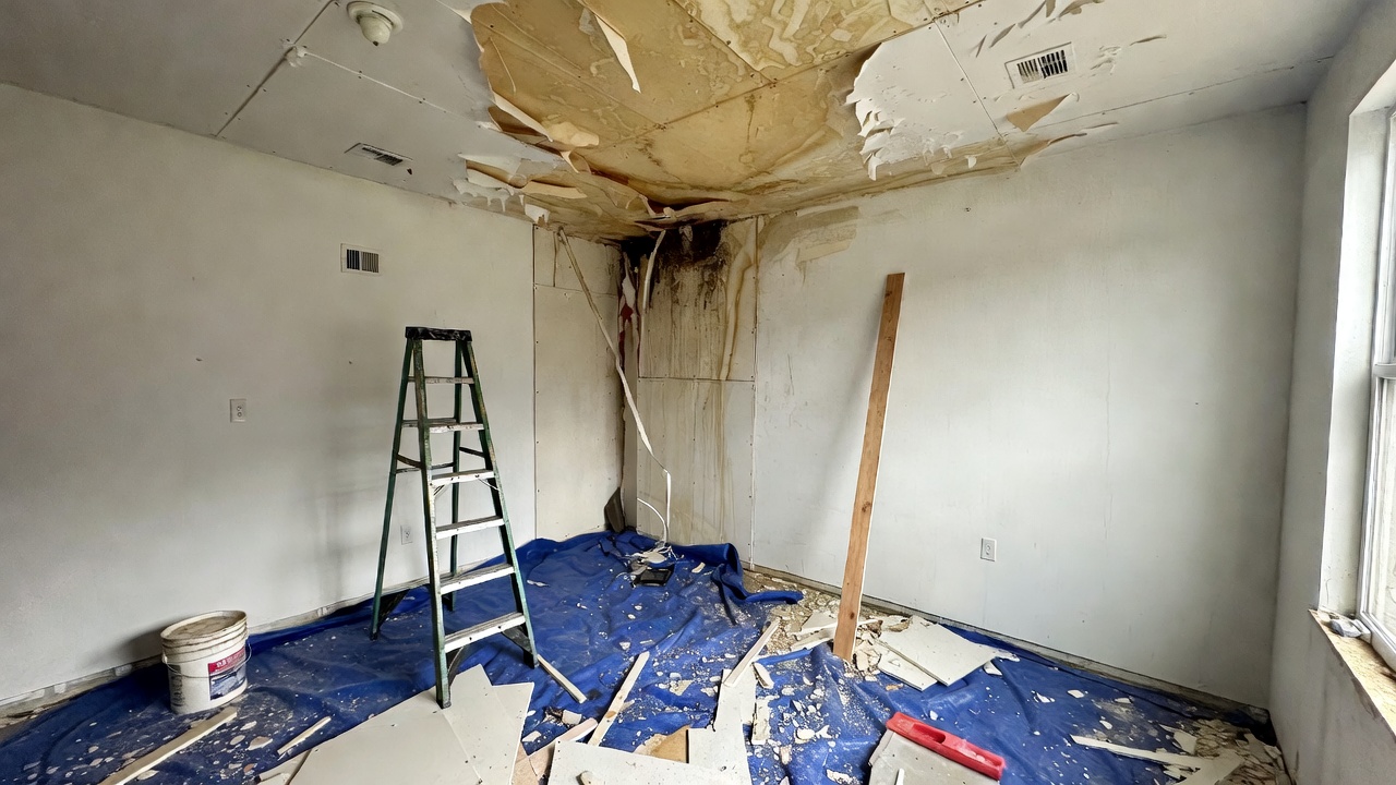 Water damage repair crew removing soaked drywall and carpet in flooded USA home 2026